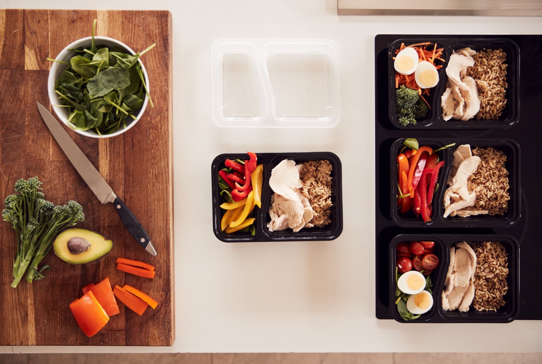 Ingredients and containers laid out for a batch of prepped meals